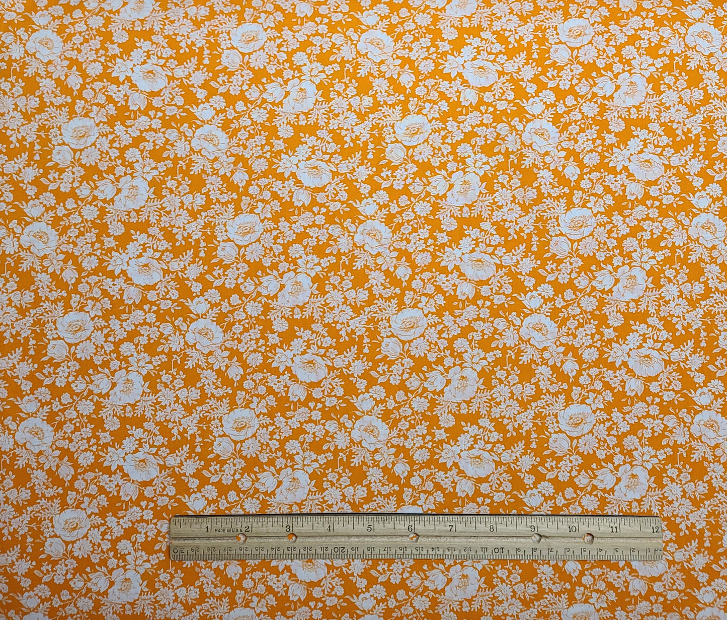 M Lowenstein & Sons Inc - Orange Fabric / White Flower Print