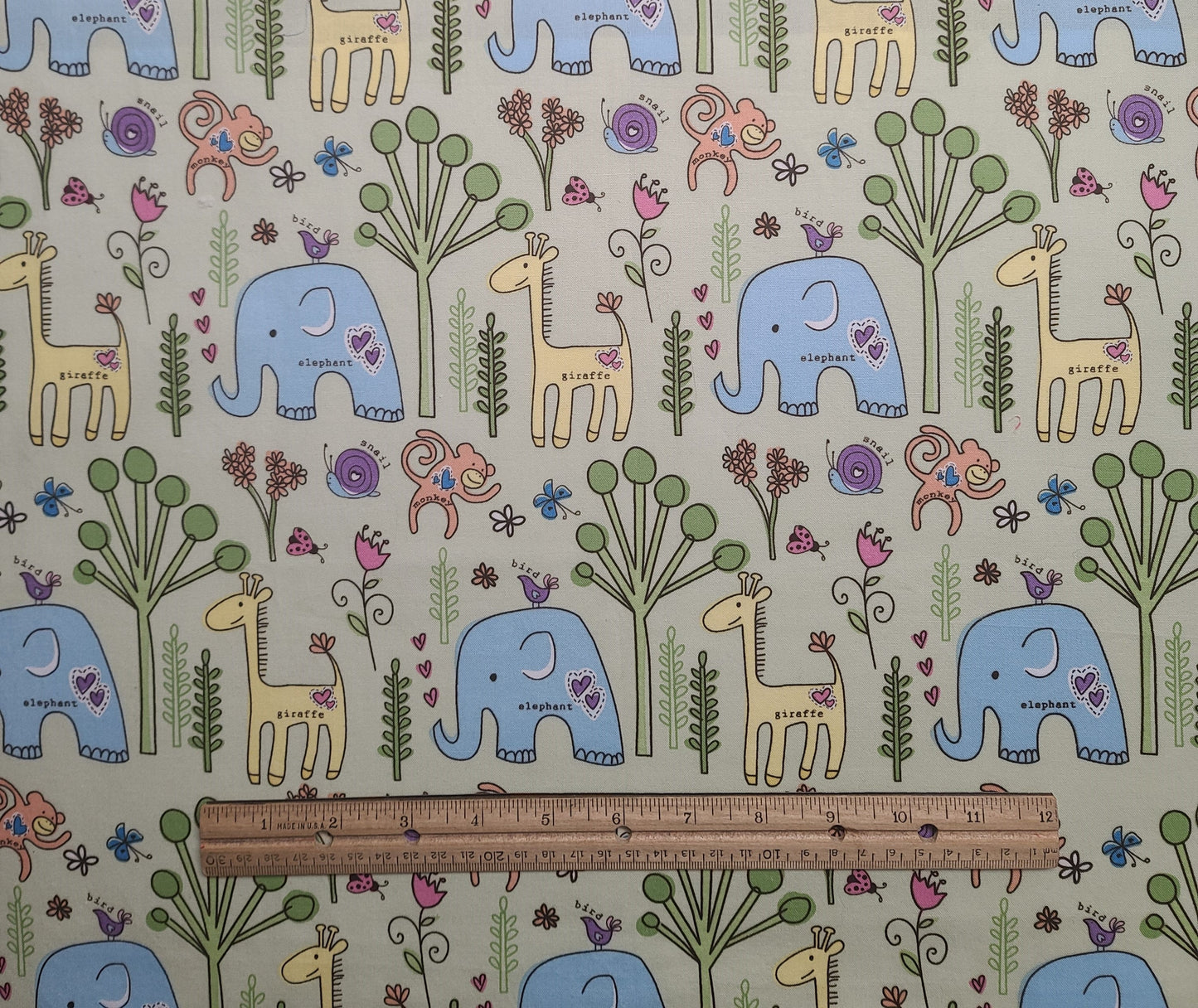EOB - Colorbok for JoAnn Fabrics - Pale Green Fabric / Cartoon-Style Jungle Print / Elephant, Monkey, Giraffe / Pastel Blue, Yellow, Purple