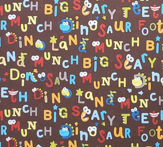 Dark Brown Fabric / Bright Blue, Red, Green Cartoon-Style Dinosaur and Script Print