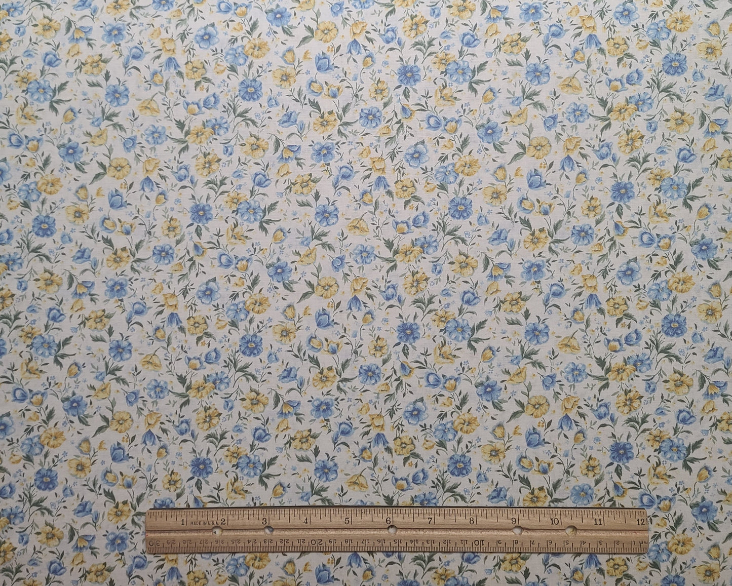 EOB - Faye Burgos Marcus Brothers Textiles Inc - Soft White Fabric / Blue, Yellow Flower Print