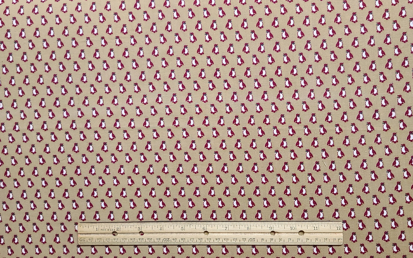 An Ameritex Fabric - Tan Fabric / Red Penguin Print