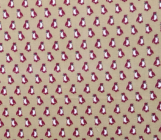 An Ameritex Fabric - Tan Fabric / Red Penguin Print