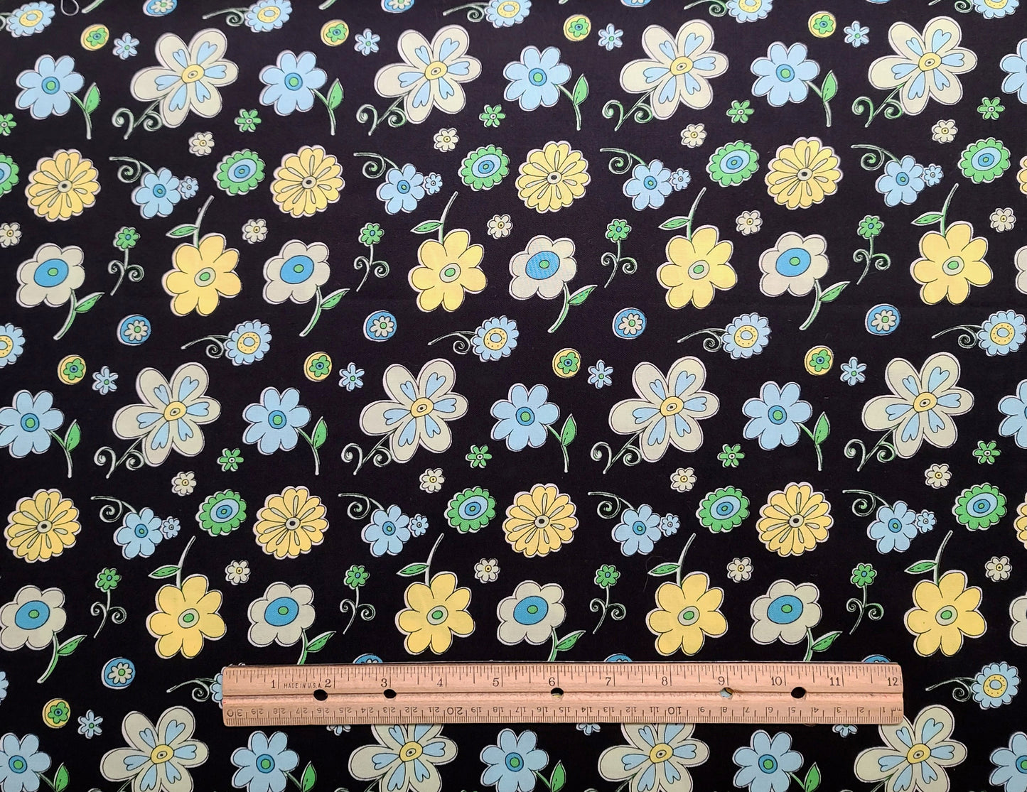 Patt BTR-3641 Black Textiles Inc - Black Fabric / Blue and Yellow Cartoon-Style Flower Print