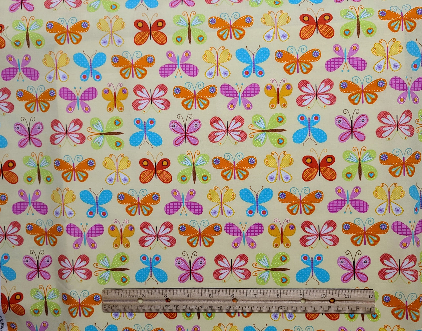 EOB - Timeless Treasures Fabrics SoHo Patt#BUTTERFLY-C3750 - Pale Yellow Fabric / Brightly Colored Pink, Orange, Blue, Green Butterfly Print.