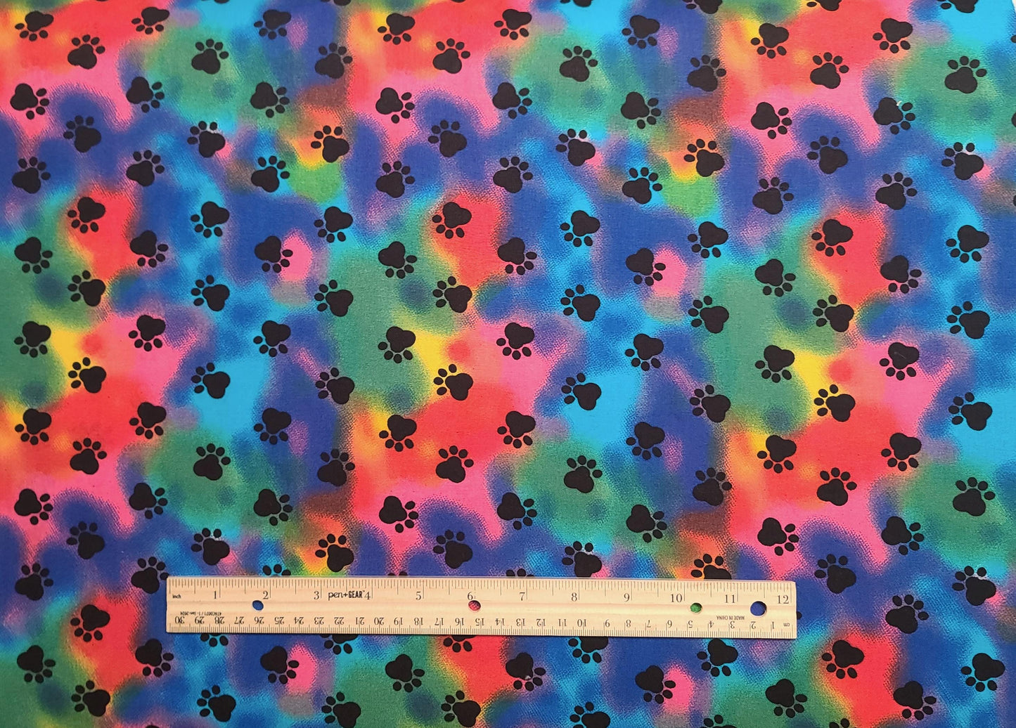 JoAnn Fabrics - Rainbow Swirl Fabric / Black Paw Prints