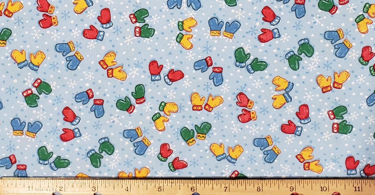 JoAnn Fabric - Light Blue Snowflake Fabric with Red, Yellow, Blue and Green Scattered Mitten Pattern