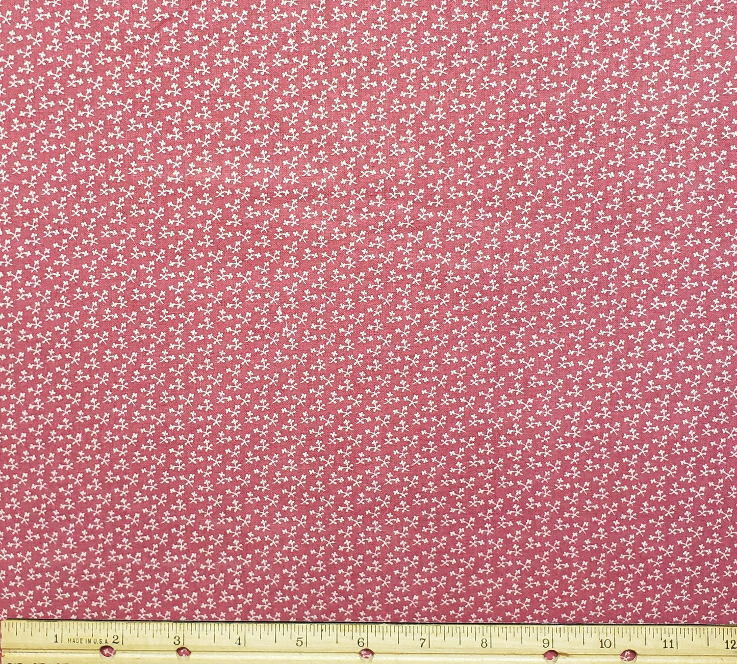 Marcus Bros. Textiles, Inc.  - Colonial Dark Pink Fabric with Tiny White Flower Print