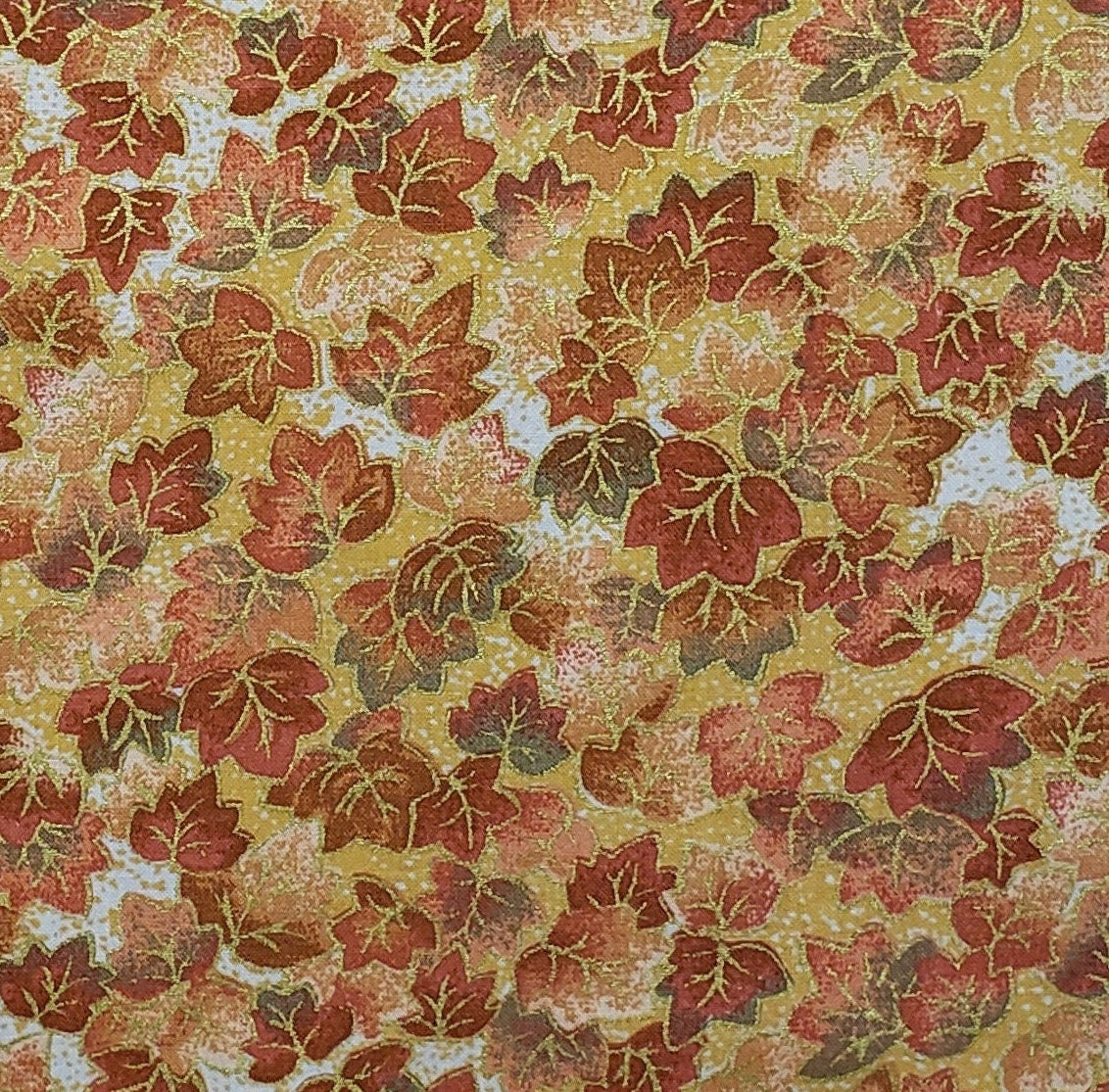Gold Fabric with Orange and Green Leaf Print with Gold Metallic Outline