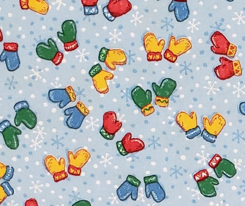 JoAnn Fabric - Light Blue Snowflake Fabric with Red, Yellow, Blue and Green Scattered Mitten Pattern