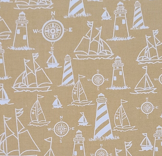 Marcus Brothers Textiles Inc - Golden Tan Fabric / White Lighthouse, Sailboat and Windrows Pattern.